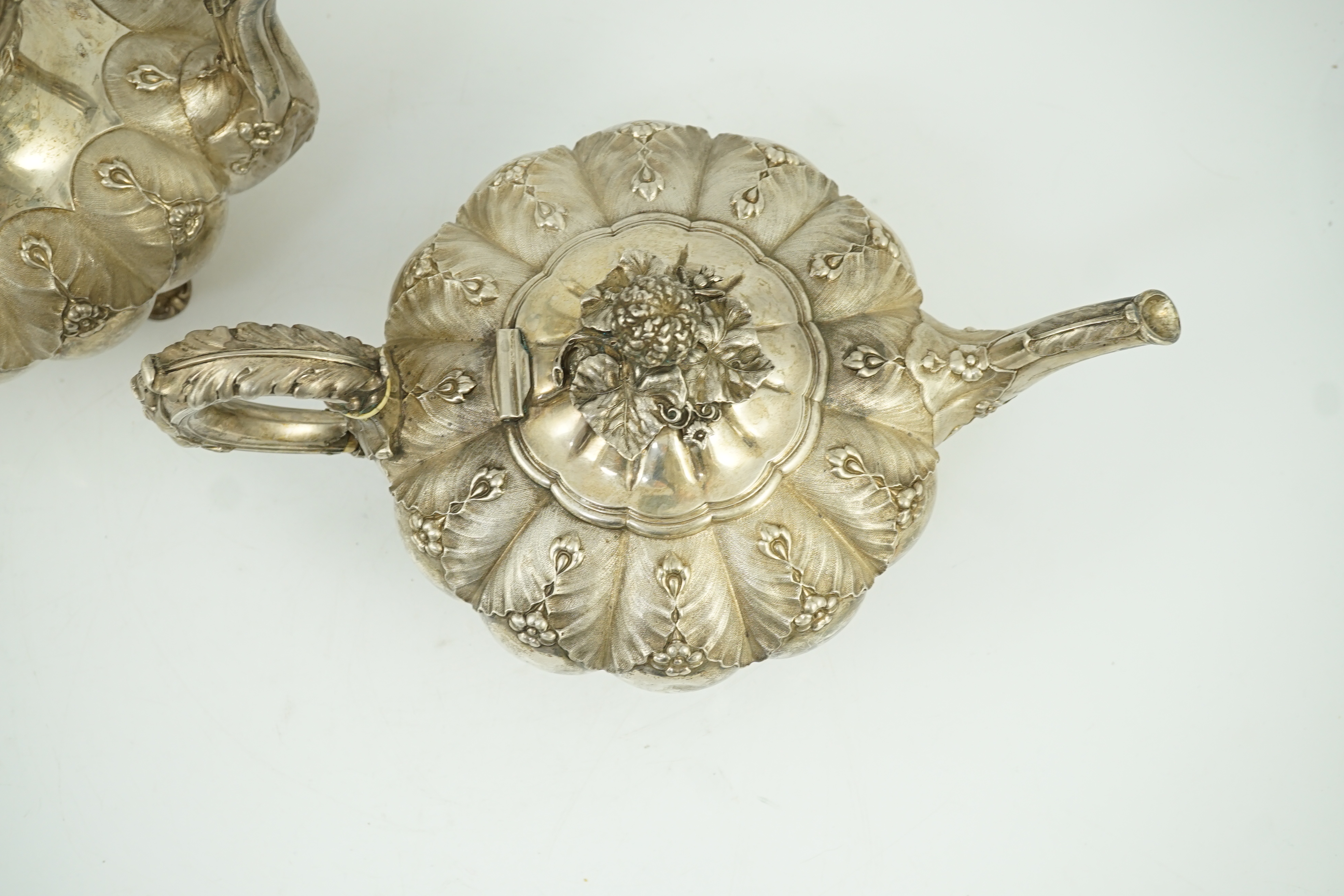 A George IV silver melon shaped coffee pot and matching tea pot by The Barnards